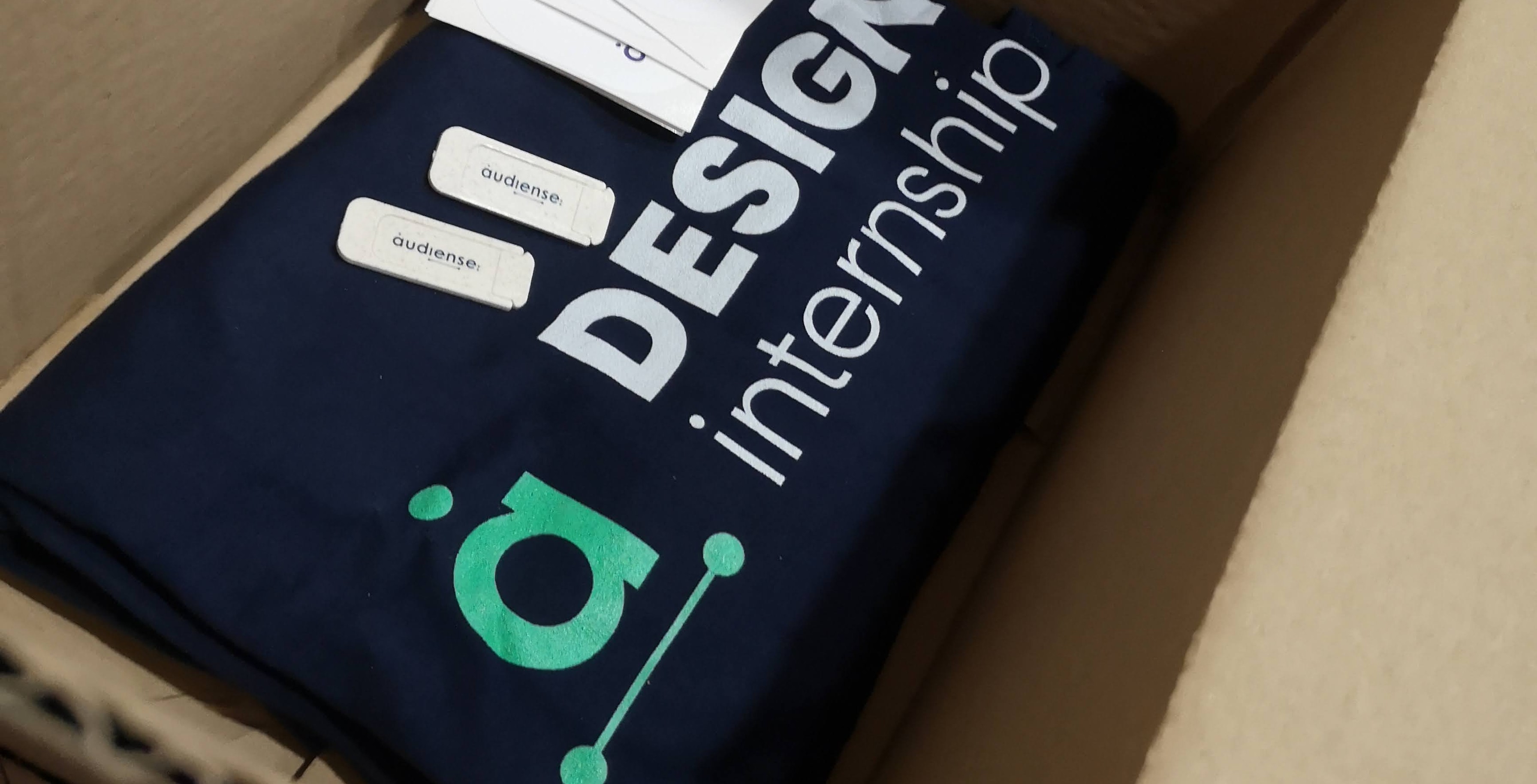 An open box with the design internship shirt